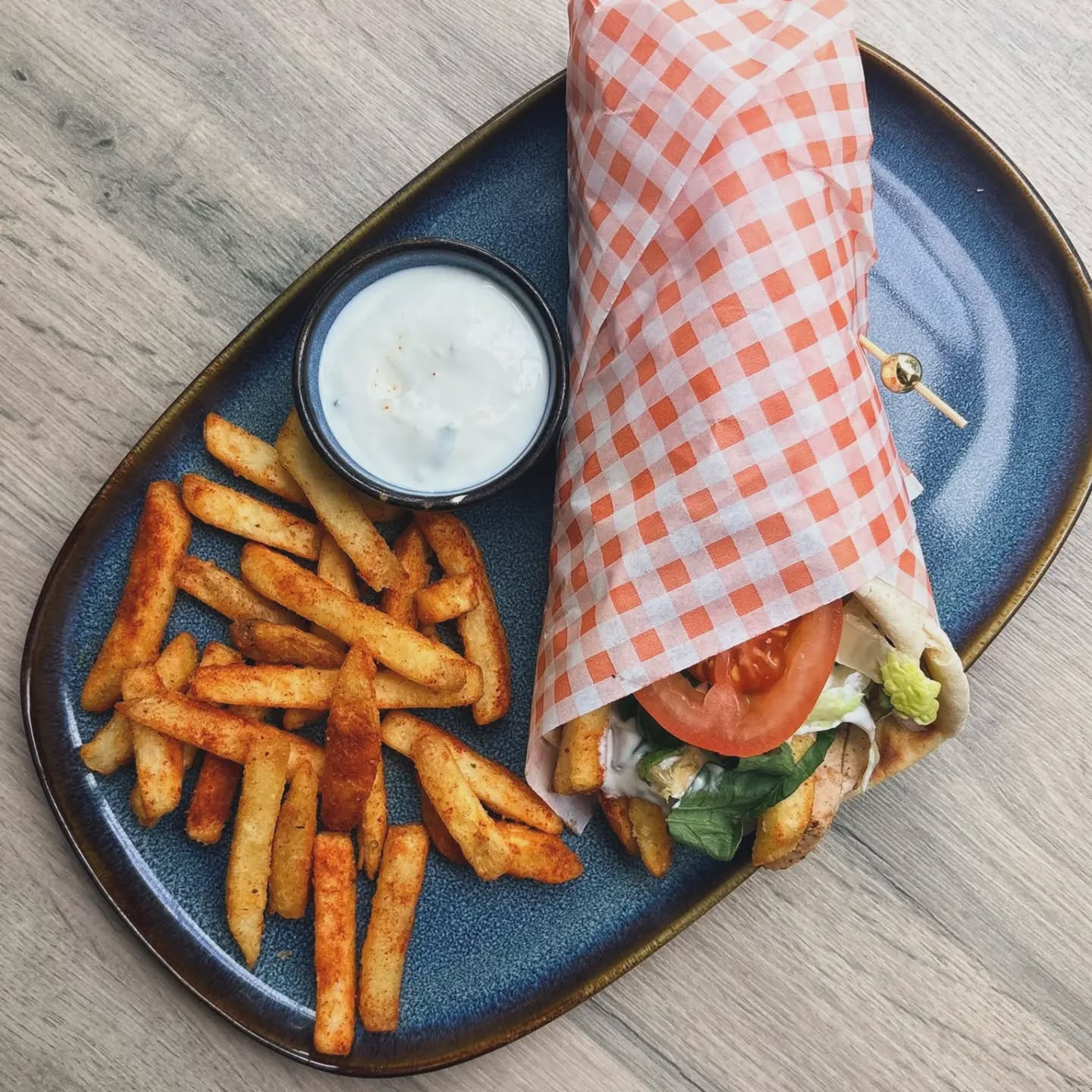 Chicken wrap with seasoned fries and garlic dip